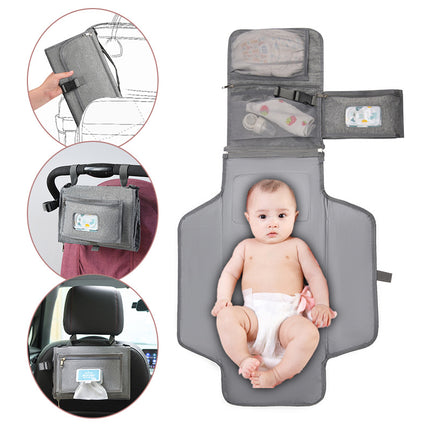 Portable baby changing pad laid flat showing waterproof surface and compact design
