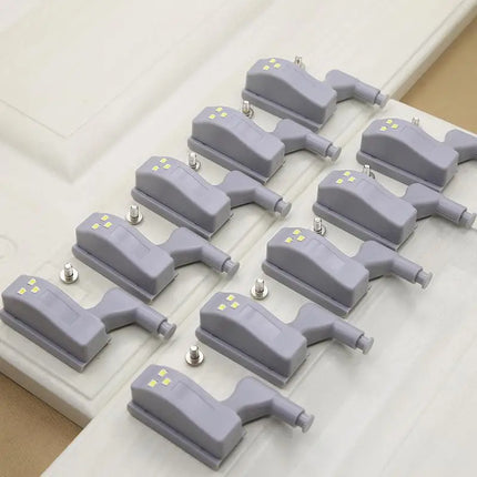 Close-up of LED Cabinet Hinge Lights attached to cabinet hinge hardware