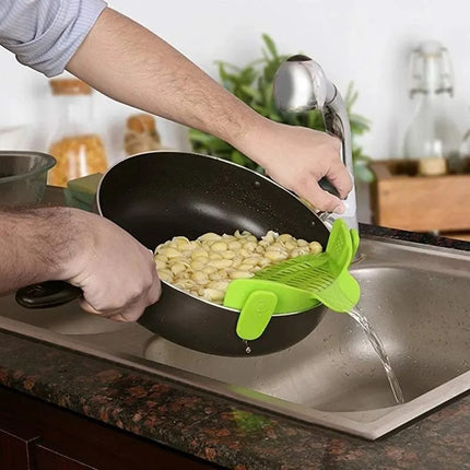 Universal Silicone Strainer Clip in use straining boiling water from pot on stove