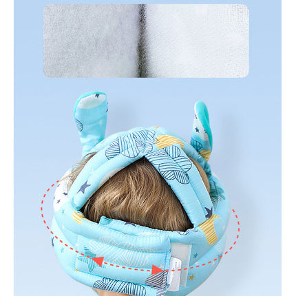 Toddler wearing safety head guard helmet during playtime fall prevention