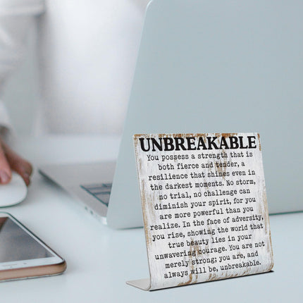 Letrero de escritorio inspiracional irrompible con cita de resiliencia y fuerza