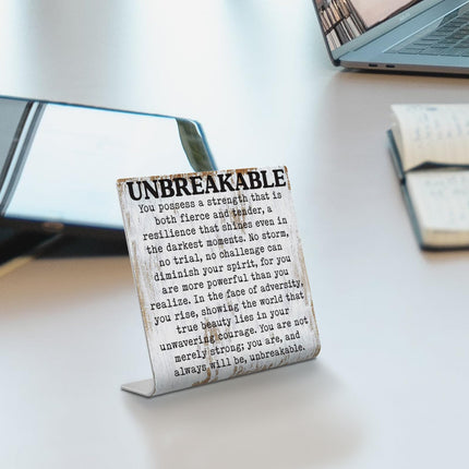 Letrero de escritorio inspiracional irrompible con cita de resiliencia y fuerza